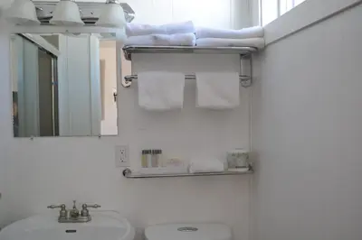 a bathroom with a sink and a toilet and a mirror at St. Paul Lodge in St. Paul