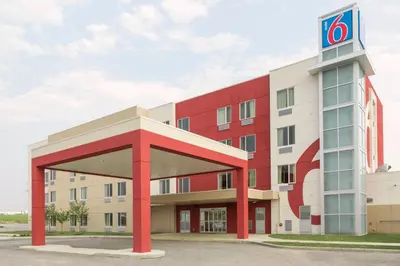 a building with a sign on top of it at Motel 6 Airdrie in Airdrie