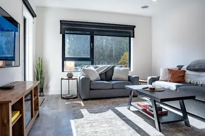 a living room with a couch and a table at Mountainview Escape by Revelstoke Vacations in Revelstoke