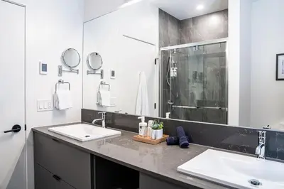 a bathroom with two sinks and a large mirror at Mountainview Escape by Revelstoke Vacations in Revelstoke