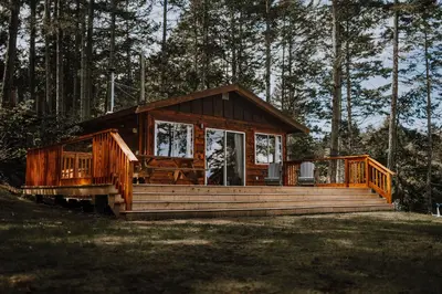 a wooden cabin in the middle of a forest at Page's Resort & Marina in Gabriola