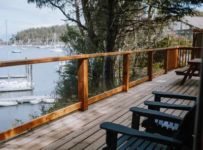 a deck with two benches and a view of the water at Page's Resort & Marina in Gabriola