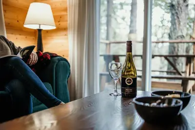 a bottle of wine and a glass on a table at Page's Resort & Marina in Gabriola