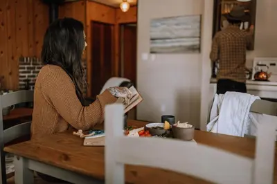 a woman sitting at a table in a kitchen at Page's Resort & Marina in Gabriola