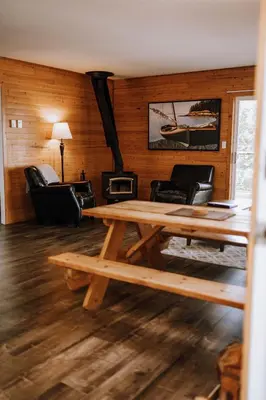 a living room with a wooden table and chairs at Page's Resort & Marina in Gabriola