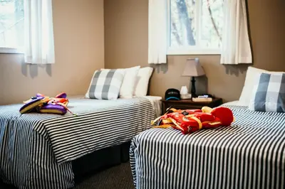 two beds with stuffed animals on them in a room at Page's Resort & Marina in Gabriola