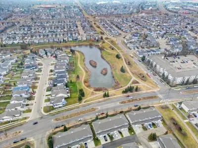 an aerial view of a city with a park at Large Townhome Near Anthony Henday in Ellerslie with Driveway & Visitor Parking, King Bed, 4 Queen Beds, Fully Equipped Kitchen & More! in Edmonton