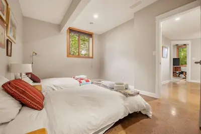 a large white bedroom with a large bed in it at Escape to the Rockies but near Calgary Includes Free Parking and Banff Entry in Calgary