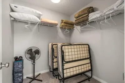 a room with several racks of pillows and blankets at Top Rated Luxury House with Central AC, Double Garage Parking, 2 Kitchens, 5 Bedrooms & More! in Balzac