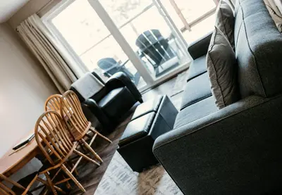 a living room with couches and a table and chairs at Page's Inn on Silva Bay in Gabriola