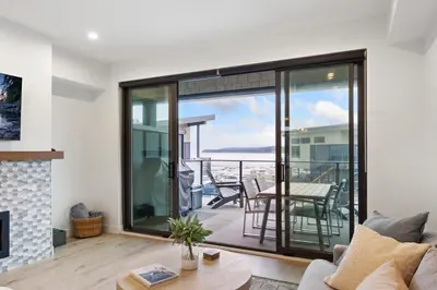 a living room with a view of the ocean at Coastal Haven at THE BEACH HOUSE in Campbell River