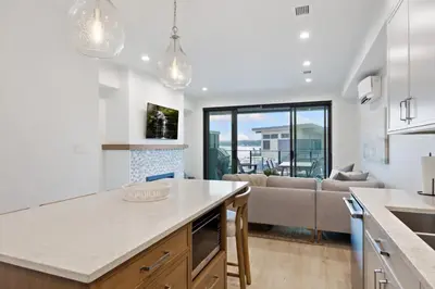 a kitchen and living room with a couch at Coastal Haven at THE BEACH HOUSE in Campbell River