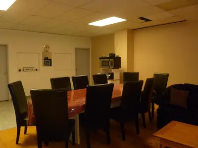 a conference room with a wooden table and chairs at Vernon Hostel in Vernon