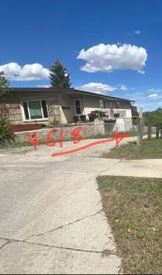 a house with red writing on the side of the road at Forth Street 2Bedroom Suite in Calgary