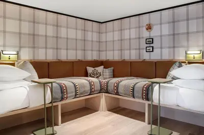two beds sitting next to each other in a room at Moxy Banff in Banff