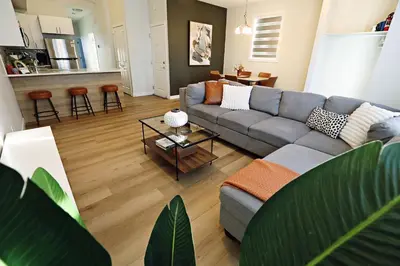 a living room with a couch and a table at Downtown 5 Bedroom, AC, Rogers, Commonwealth, EXPO in Edmonton