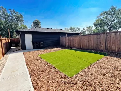 a garden with a smallificialificialificialificialificialificialificialificialificialificial yard at Central 3 Queen Beds, AC, Double Garage, Disney in Edmonton