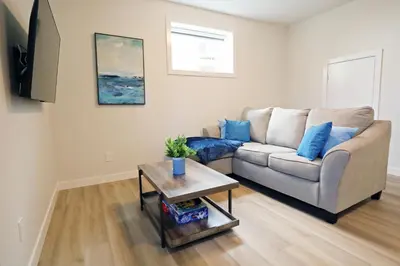 a living room with a couch and a table at Central Suite King Beds,Long Stays,Disney+ in Edmonton