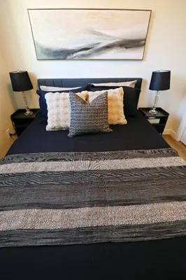a bedroom with a large bed with pillows on it at Central 5 Bedroom, AC, Rogers, Commonwealth, EXPO in Edmonton