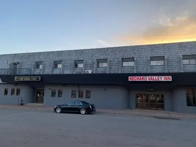 a black car parked in front of a building at Nechako Valley Inn in Vanderhoof
