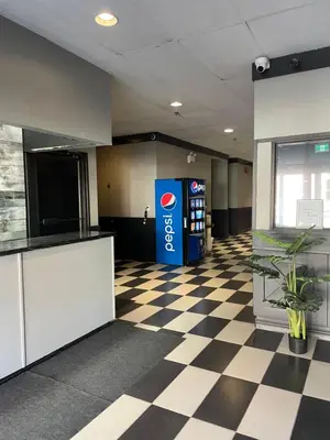 an office lobby with a soda machine and a checkered floor at Nechako Valley Inn in Vanderhoof