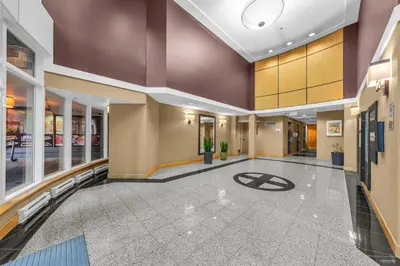 an empty lobby of a hospital with a sign on the floor at 1-BR Condo in Downtown Coal Harbour with Parking and City Views in Vancouver