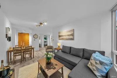 a living room with a couch and a table at 1-BR Condo in Downtown Coal Harbour with Parking and City Views in Vancouver