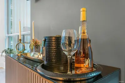 a bottle of wine and a glass on a table at 1-BR Condo in Downtown Coal Harbour with Parking and City Views in Vancouver