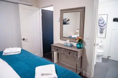a bedroom with a blue bed and a mirror at Peak Paradise by Revelstoke Vacations in Revelstoke