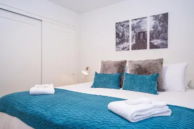 a bedroom with a large bed with towels on it at Peak Paradise by Revelstoke Vacations in Revelstoke