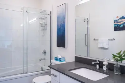 a bathroom with a shower and a sink and a toilet at Peak Paradise by Revelstoke Vacations in Revelstoke