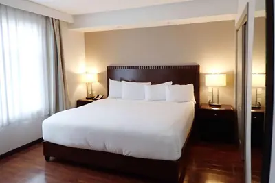 a large bed in a hotel room with two lamps at Days Inn & Suites by Wyndham Fort Saskatchewan in Fort Saskatchewan