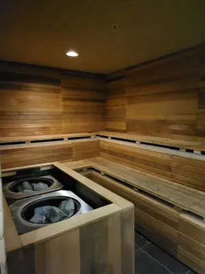 a sauna with twouzzles in a room with wooden walls at Days Inn & Suites by Wyndham Fort Saskatchewan in Fort Saskatchewan