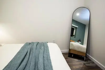 a bedroom with a bed and a mirror at The Stellar Condo - Cozy 2 Bedroom with Hot Tub in Revelstoke