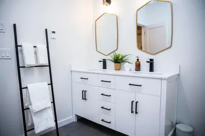 a bathroom with a white sink and a mirror at The Stellar Condo - Cozy 2 Bedroom with Hot Tub in Revelstoke