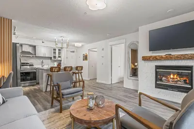a living room with a couch and a fireplace at W116 NEW! Central Canmore- Whimsical Mountain Retreat in Canmore
