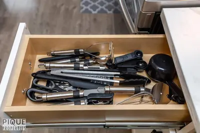 a drawer full of knives and utensils at Boho Suite - Long Stays - King Bed - Fireplace & WiFi in Edmonton