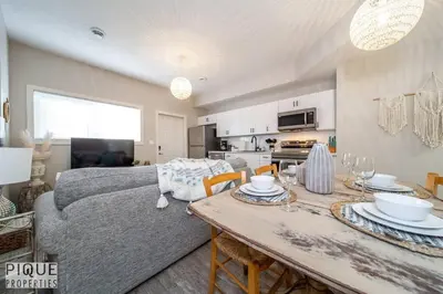 a living room with a couch and a table at Boho Suite - Long Stays - King Bed - Fireplace & WiFi in Edmonton