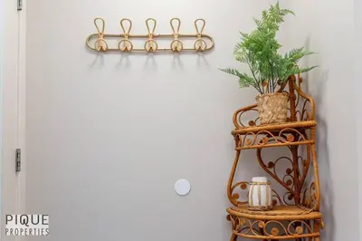 a shelf with a plant on it next to a wall at BoHo Chic Suite - Long Stays - Fireplace - Garage in Edmonton