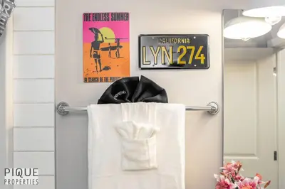 a towel rack in a bathroom with a movie sign at BoHo Chic Suite - Long Stays - Fireplace - Garage in Edmonton