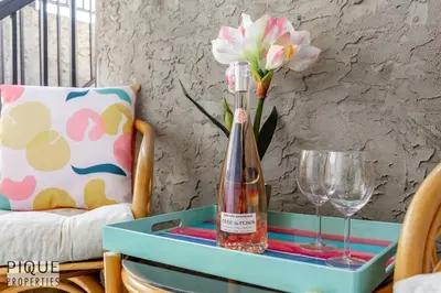 a bottle of wine on a table with a glass at BoHo Chic Suite - Long Stays - Fireplace - Garage in Edmonton