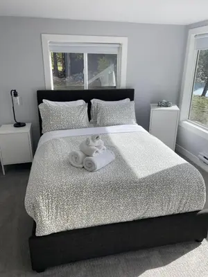 a bedroom with a bed with towels on it at River's Edge Retreat in Clearwater