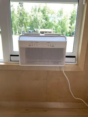 a air conditioner sitting in a window next to a radiator at River's Edge Retreat in Clearwater