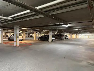 a parking garage with several cars parked in it at W118 NEW! Central Canmore- Light Industrial Hotel Room in Canmore