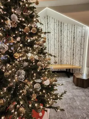 a christmas tree in a living room with a bench at W118 NEW! Central Canmore- Light Industrial Hotel Room in Canmore