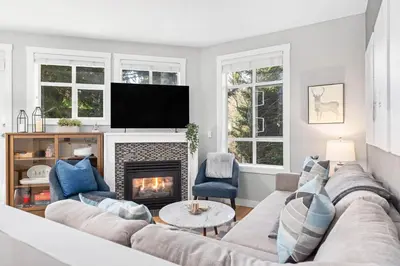 a living room with a couch and a fireplace at 2BR in Granite Court, Village Location, Gas Fireplace, Mudroom, Secure Parking in Whistler