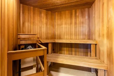 a sauna with wooden walls and wooden shelves at 1BR in Marquise, Near Ski Hill, Fireplace, Heated Pool, Hot Tub, Sauna, Gym, Free Shuttle in Whistler