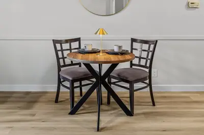 a wooden table with two chairs and a lamp on it at G222 Family Fun- MTN View Stay, Water slide, Pool, Hot Tub, Free Parking in Canmore