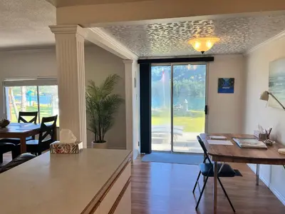 a kitchen and dining room with a table and a window at Waterfront, Mountainview House in Castlegar in Castlegar