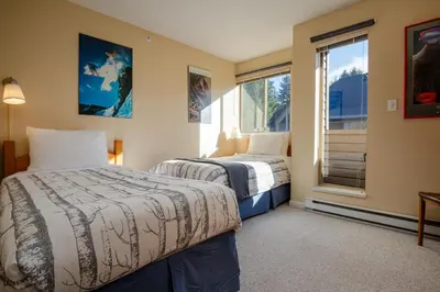 a bedroom with two beds and a window at 2BR in Valhalla, Whistler Village, Complex Hot Tub, Gas Fireplace, Parking, Gondola Shuttle in Whistler